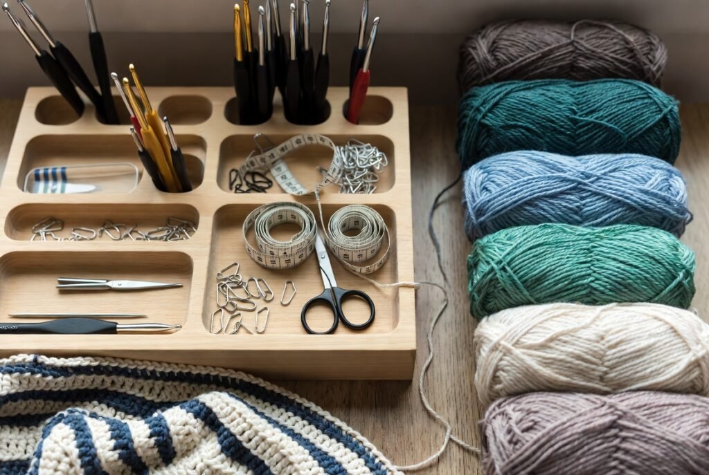 Crochet tools organizer holding hooks, scissors, stitch markers, and yarn, used for organizing and storing essential crochet tools safely and neatly.