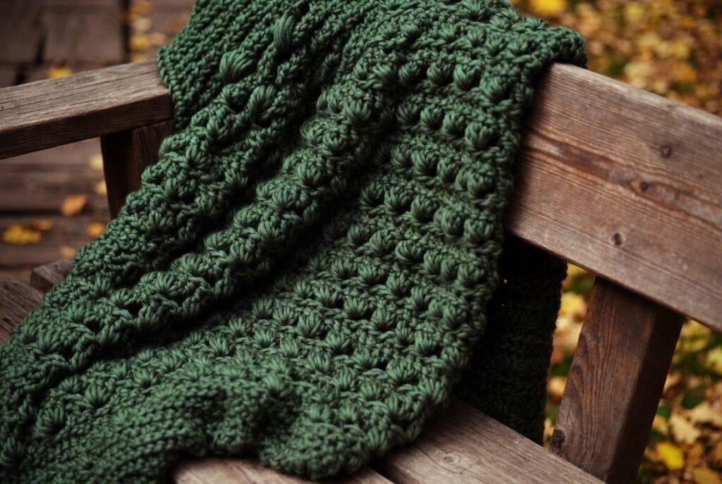 Waffle stitch crochet blanket with thick grid texture and cozy winter design made using front post stitches.