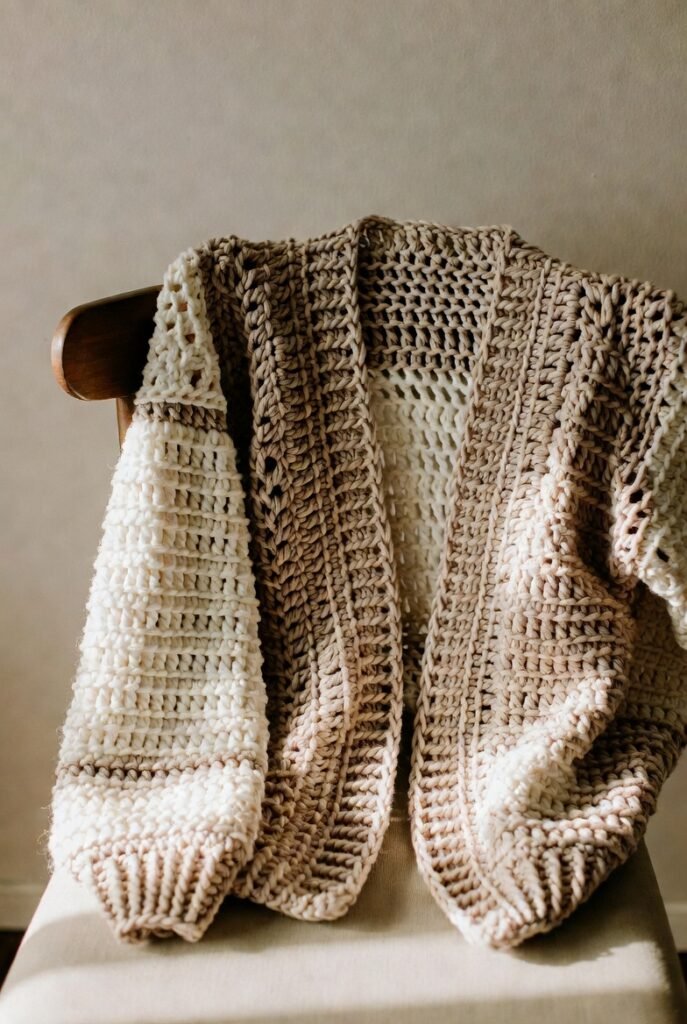 Handmade crochet cardigan with open front and long sleeves.