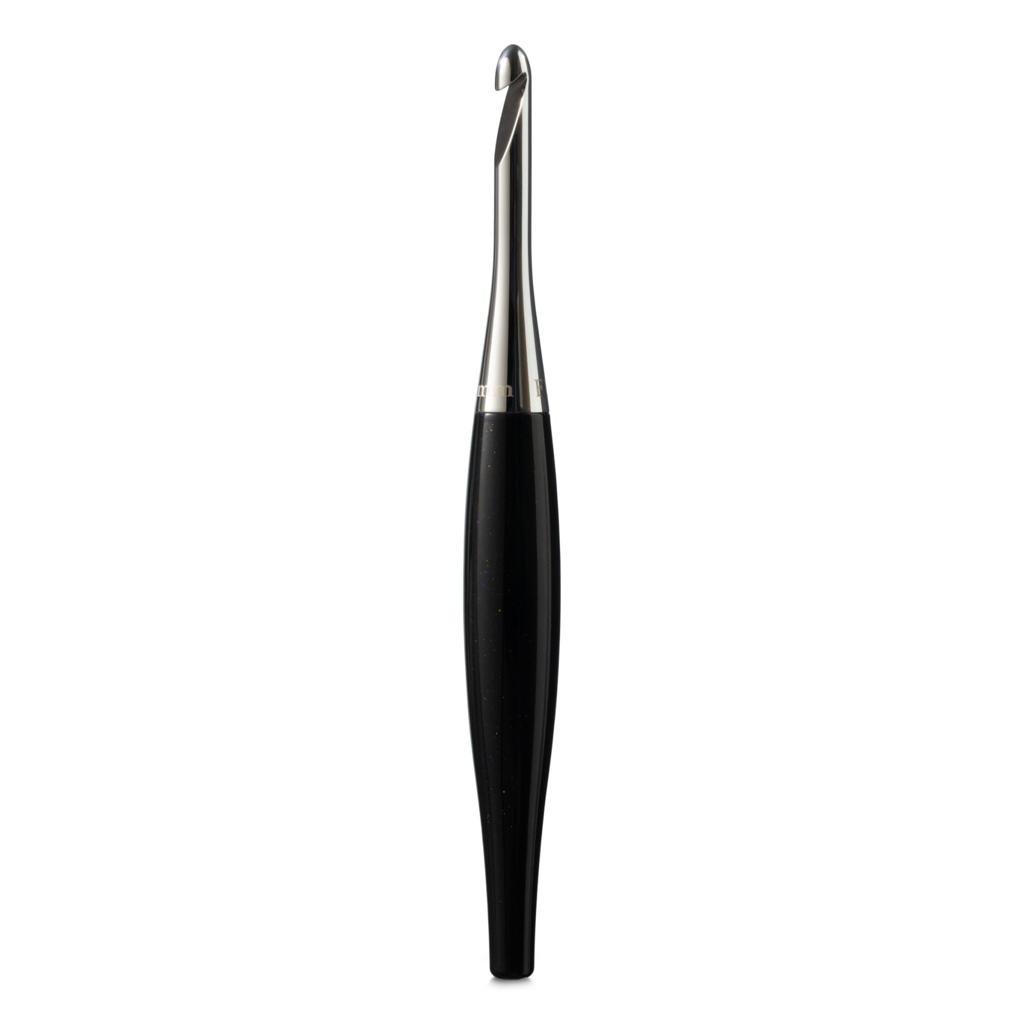 Furls Odyssey ergonomic crochet hooks with glossy handles and metal hook tips on a craft table.